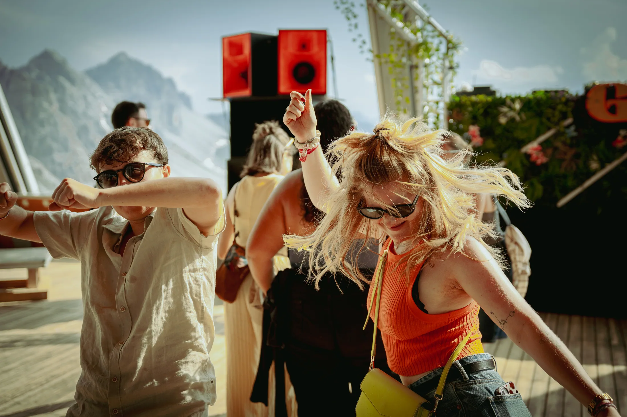 Friends dancing together at Gaudi Hoadl Day Festival in the summer sun