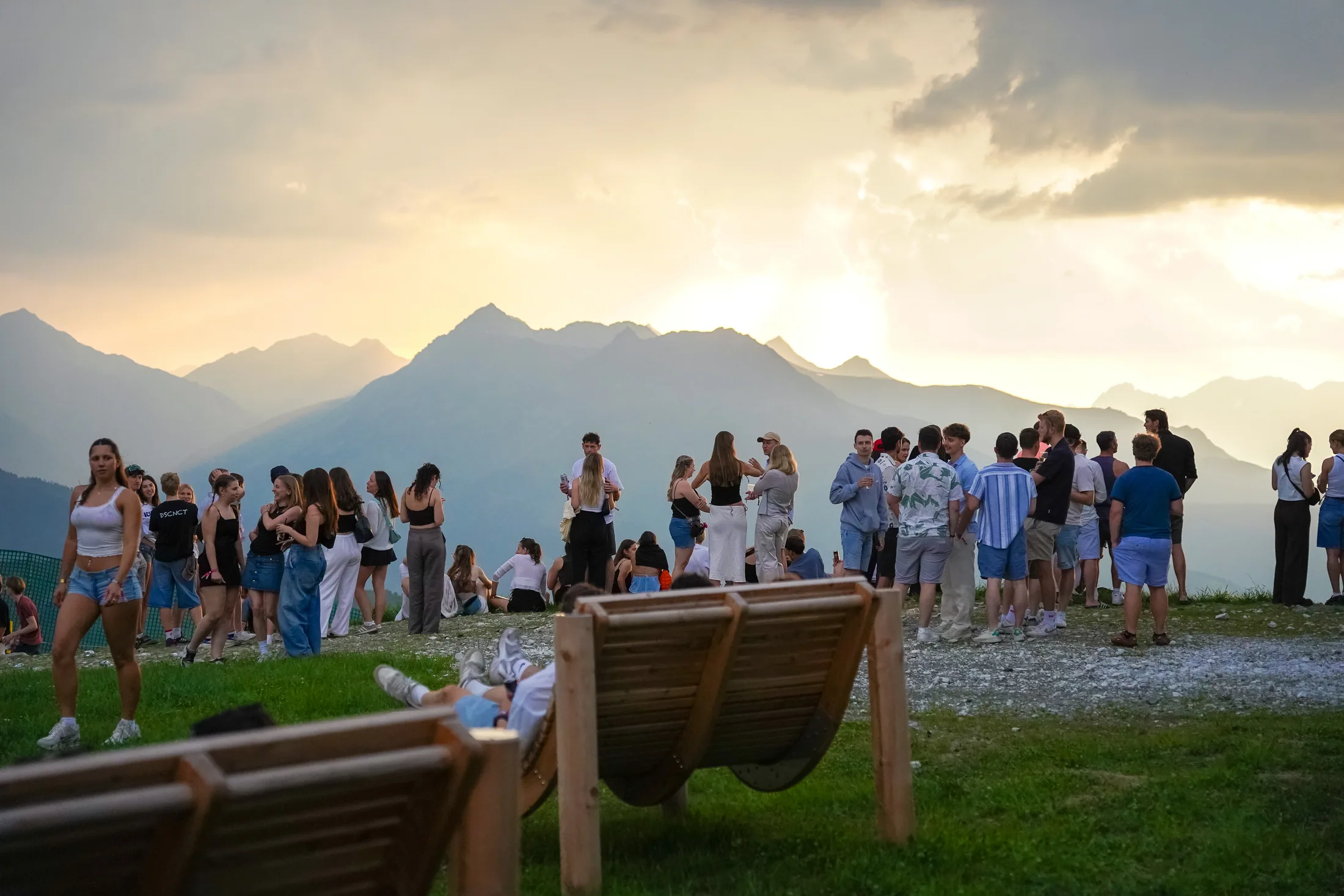 Festival guests watching sunset across the Tyrolean mountains