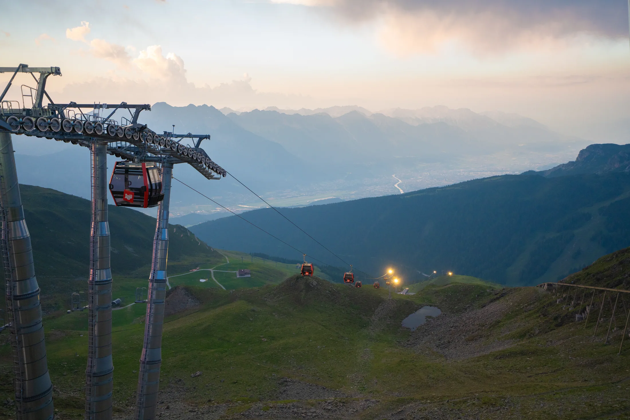 The red Axamer Lizum lift crossing the summer mountain